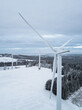 Wind turbine in a snowy winter landscape seen from an aerial view