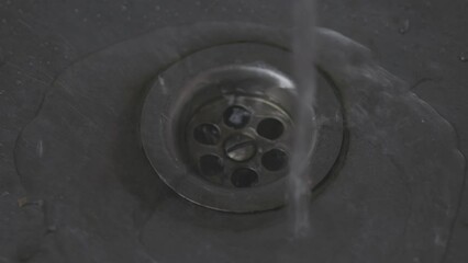 Poster - tap water flows into a tin sink. smooth zoom