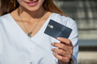 Close-up of a smiling girl's credit card ready to shop online.