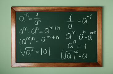 Wall Mural - Chalkboard with many different math formulas on green wall