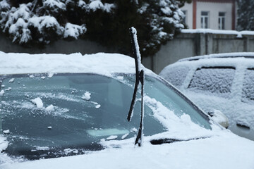 Wall Mural - Car windshield with wiper blades cleaned from snow outdoors on winter day