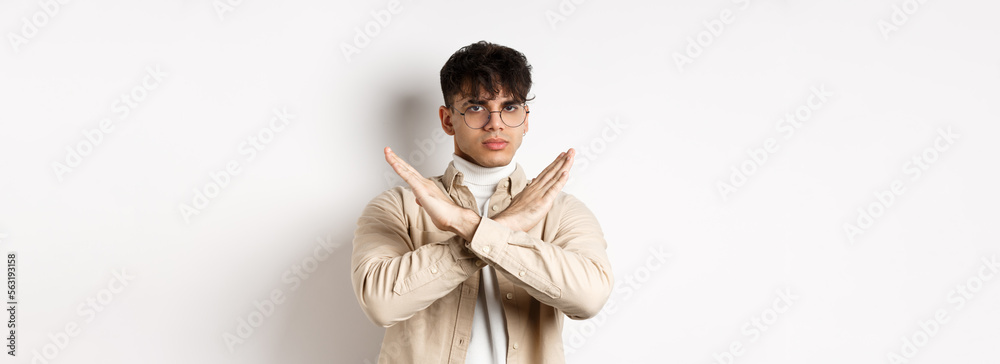 Man Disagree Sign Image of serious young guy in glasses say no, showing cross gesture ...