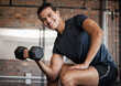 © Jordan C/peopleimages.com - Portrait, fitness and dumbbell with a sports man training in a gym for strong or healthy muscles. Happy. exercise and weightlifting with a male athlete or bodybuilder in a health club for a workout