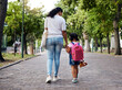 © Nina/peopleimages.com - Mother, child and walking with backpack holding hands to school for safety at the outdoor park. Mom with little girl or daughter having a walk together for safe travel, trip or care for childhood