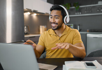 Poster - Happy man, headphones and video conference on laptop in home office while online, talking and on webinar. Entrepreneur person at desk working remote with virtual communication for freelance work