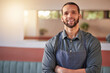 © Alexis S/peopleimages.com - Restaurant, waiter portrait and man with arms crossed ready to take your order. Small business, server and confident, happy and proud young male employee from Brazil, worker or startup business owner