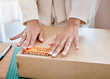 © J Maas/peopleimages.com - Hands, logistics and fragile box for shipping, delivery or package in ecommerce, cargo or inventory at workshop. Hand of business owner packaging item, object or label stock, service or sticker sign