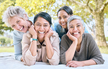 Canvas Print - Senior women and friends portrait on picnic in park for bonding, wellness and relaxing lifestyle. Happiness, joy and smile of elderly retirement people in interracial friendship in nature together.