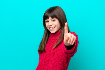 Little caucasian girl isolated on blue background showing and lifting a finger