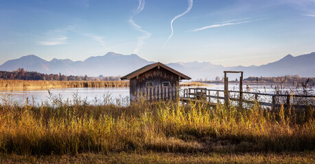 Fotobehang - Scenic nature landscape. Sunrise on Chiemsee lake with vivid sky. Wonderful sunny mountain valley under sunlight Beautiful alpine summer view near Rimsting at famous Chiemsee, Bavaria, Germany