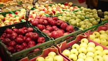 Red And Green Apples Of Various Varieties Are Sold In The Shop Window.