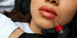 Woman's lips during permanent makeup procedure