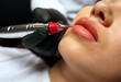 Woman having lip powder permanent makeup procedure