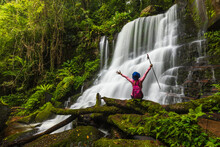 Young Woman Hiking On Beautiful Waterfall In Phu Hin Rong Kla National Park, Phitsanulok  Province, ThaiLand.