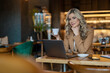 © ivanko80 - Businesswoman working online from cafe