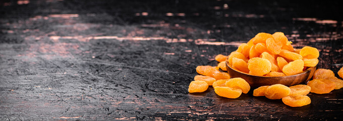 Poster - Full wooden plate with dried apricots. 