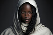 Close-up portrait of a young, beautiful black woman with long hair and a white hood on a dark background - not based on a real person, Generative AI