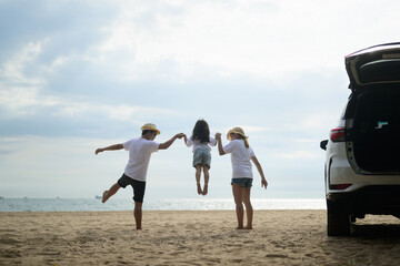 Wall Mural - family playing at the beach. happy asian family playing fun on beach