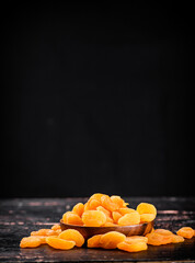 Canvas Print - Full wooden plate with dried apricots. 