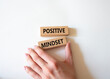 © Natallia - Positive Mindset symbol. Concept words Positive Mindset on wooden blocks. Businessman hand. Beautiful white background. Business and Positive Mindset concept. Copy space.