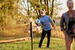 © Flamingo Images - Laughing family playing volleyball in summer