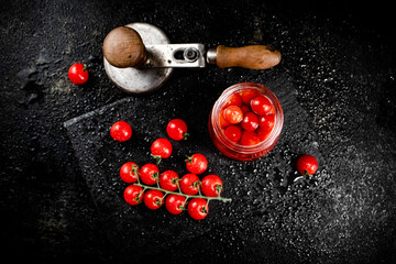 Canvas Print - Pickled tomatoes in a jar on a stone board. 