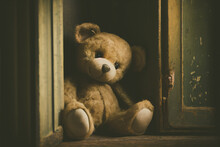 Small Brown Teddy Bear Sitting Alone In An Old, Abandoned House. Generative AI