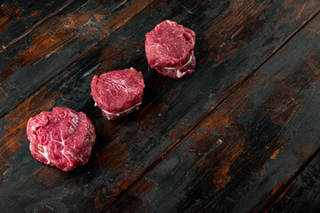 Wall Mural - Fresh raw fillet minion steaks marbled beef with rosemary and garlic, on old dark  wooden table background, with copy space for text