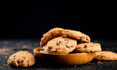 Poster - Delicious cookies with pieces of milk chocolate on a plate.