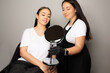 Beautician holding a mirror for a client
