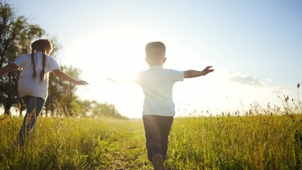 Wall Mural - happy family kids. people in the park children child running together in the park at sunset silhouette. mom dad daughter and son are run happy family and little child in summer fun. dream kids run