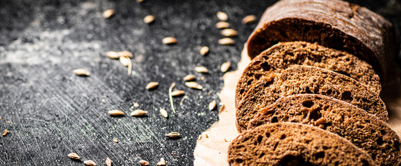 Wall Mural - Sliced rye bread on paper. 