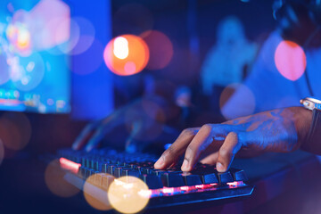 Wall Mural - Banner keyboard for game blur bokeh background soft focus. Hand of Professional African cyber video gamer, neon color