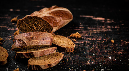 Wall Mural - Sliced bread. Against a dark background.