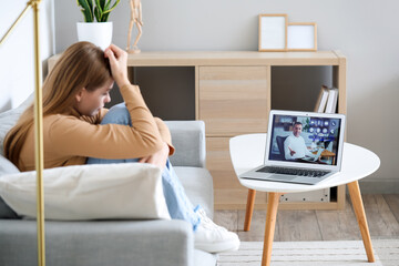 Poster - Stressed young woman video chatting with psychologist on laptop at home