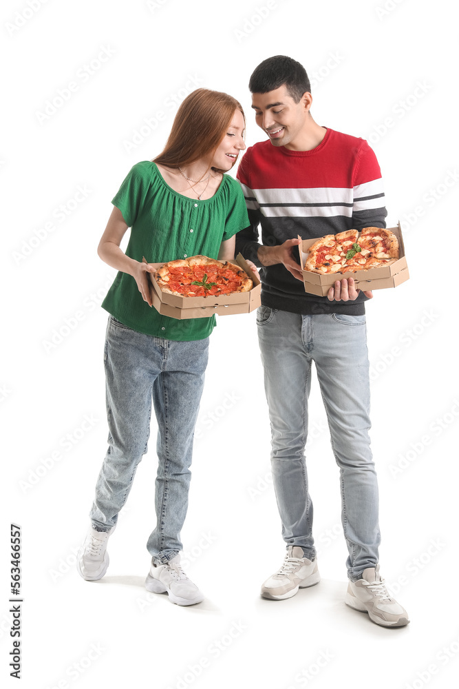 Young couple with boxes of tasty pizza on white background