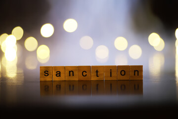 Wall Mural - Word Sanctions made of wooden block letters with dramatic lighting and smoke