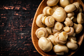 Poster - Pickled mushrooms in a wooden plate on the table. 