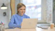 © stockbakers - Woman Doing Online Video Chat in Office