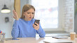 © stockbakers - Upset Woman Reacting to Loss on Smartphone