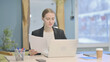 © stockbakers - Businesswoman Working on Laptop and Documents