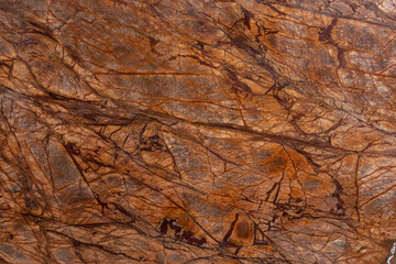 Bidasar Brown. Rainforest Brown Detail slab photo. Light brown marble, chaotic rugged dark brown and beige stripes. Natural materials for interior decoration. Natural stone for use in interior design.