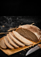 Poster - Sliced rye bread on a cutting board.