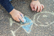 Chalk Drawing made by a child on the floor, stylized smiling child
