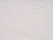 White leather texture sample. Genuine leather closeup in light white tone. Background with copy space, top view. Backdrop textured effect for design, upholstered furniture, clothing. Faux eco leather.