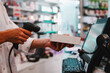© alphaspirit - Pharmacist uses barcode reader to identify and sell a drug