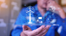 Engineer Using AI Artificial Intelligence To Inspect Wind Turbine By Examining The Quality And Efficiency Of Electricity Generated Through The Hologram HUD, Energy Conservation Concept And Technology.