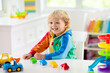© famveldman - Boy playing toy cars. Kid with toys. Child and car