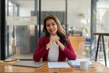 Wall Mural - Young woman working with a laptop. Female freelancer connecting to internet via computer. Businesswoman at work.