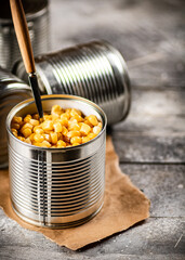 Sticker - An open can of canned corn with a spoon. 